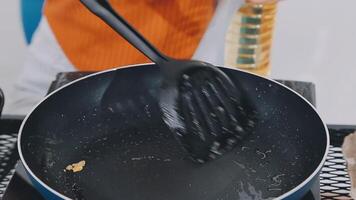 detail shot of a woman removing an egg from the frying pan with a spatula, preparing the typical colombian breakfast video