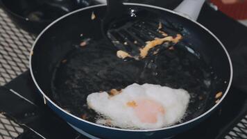 detail shot of a woman removing an egg from the frying pan with a spatula, preparing the typical colombian breakfast video