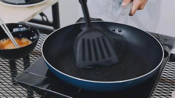 detail shot of a woman removing an egg from the frying pan with a spatula, preparing the typical colombian breakfast video