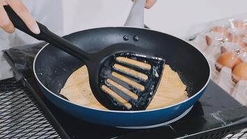detail shot of a woman removing an egg from the frying pan with a spatula, preparing the typical colombian breakfast video