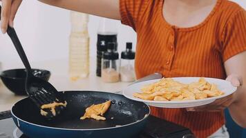 detail shot of a woman removing an egg from the frying pan with a spatula, preparing the typical colombian breakfast video