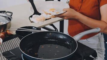 detail shot of a woman removing an egg from the frying pan with a spatula, preparing the typical colombian breakfast video