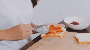 Detail of female hands adding salami on a sandwich woman making hot sandwiches for breakfast in a sandwich maker video