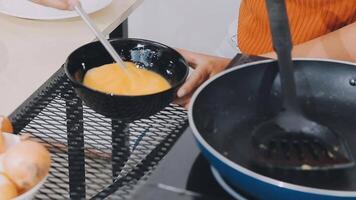detail shot of a woman removing an egg from the frying pan with a spatula, preparing the typical colombian breakfast video