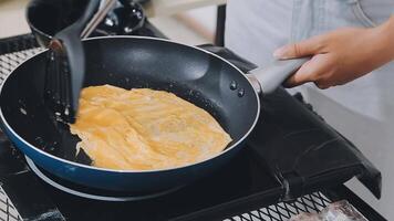 detail shot of a woman removing an egg from the frying pan with a spatula, preparing the typical colombian breakfast video