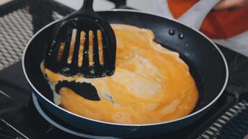 detail shot of a woman removing an egg from the frying pan with a spatula, preparing the typical colombian breakfast video