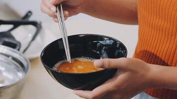 detail shot of a woman removing an egg from the frying pan with a spatula, preparing the typical colombian breakfast video