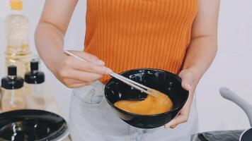 detail shot of a woman removing an egg from the frying pan with a spatula, preparing the typical colombian breakfast video