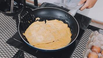 detail shot of a woman removing an egg from the frying pan with a spatula, preparing the typical colombian breakfast video