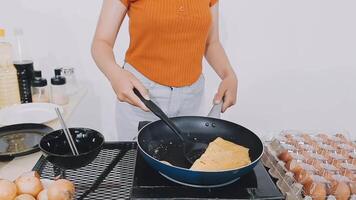 detail shot of a woman removing an egg from the frying pan with a spatula, preparing the typical colombian breakfast video