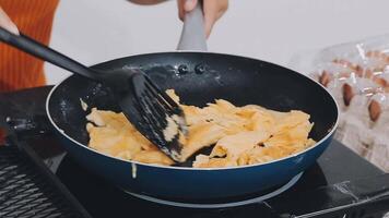 detail shot of a woman removing an egg from the frying pan with a spatula, preparing the typical colombian breakfast video