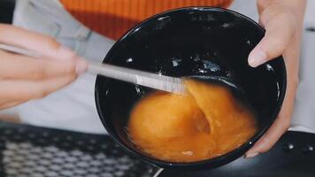 detail shot of a woman removing an egg from the frying pan with a spatula, preparing the typical colombian breakfast video