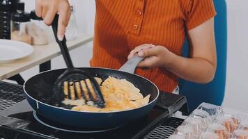 detail shot of a woman removing an egg from the frying pan with a spatula, preparing the typical colombian breakfast video