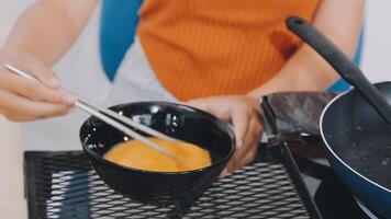detail shot of a woman removing an egg from the frying pan with a spatula, preparing the typical colombian breakfast video