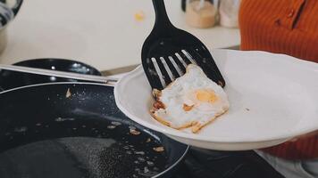 detail shot of a woman removing an egg from the frying pan with a spatula, preparing the typical colombian breakfast video