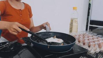 detail shot of a woman removing an egg from the frying pan with a spatula, preparing the typical colombian breakfast video