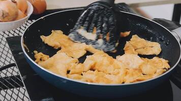 detail shot of a woman removing an egg from the frying pan with a spatula, preparing the typical colombian breakfast video