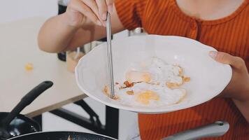 detail shot of a woman removing an egg from the frying pan with a spatula, preparing the typical colombian breakfast video