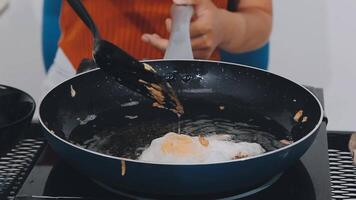 detail shot of a woman removing an egg from the frying pan with a spatula, preparing the typical colombian breakfast video