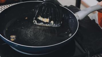 detail shot of a woman removing an egg from the frying pan with a spatula, preparing the typical colombian breakfast video