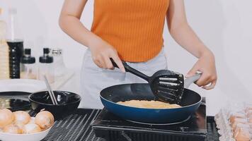 detail shot of a woman removing an egg from the frying pan with a spatula, preparing the typical colombian breakfast video