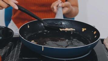 detail shot of a woman removing an egg from the frying pan with a spatula, preparing the typical colombian breakfast video