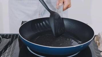 detail shot of a woman removing an egg from the frying pan with a spatula, preparing the typical colombian breakfast video