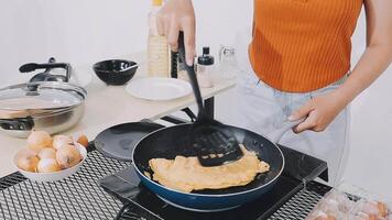 detail shot of a woman removing an egg from the frying pan with a spatula, preparing the typical colombian breakfast video