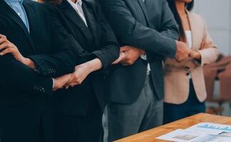 Motivated successful business team giving high five, happy young students employees group join hands with senior teacher mentor, team building unity concept, help support in teamwork, close up view photo