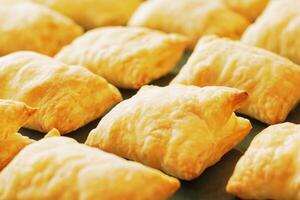 Close up view of a freshly baked pies made of puff pastry with shallow depth of field photo
