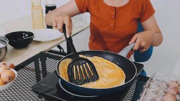 detail shot of a woman removing an egg from the frying pan with a spatula, preparing the typical colombian breakfast video