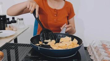 detail shot of a woman removing an egg from the frying pan with a spatula, preparing the typical colombian breakfast video