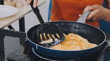 detail shot of a woman removing an egg from the frying pan with a spatula, preparing the typical colombian breakfast video