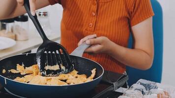 detail shot of a woman removing an egg from the frying pan with a spatula, preparing the typical colombian breakfast video