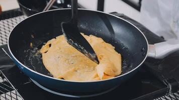 detail shot of a woman removing an egg from the frying pan with a spatula, preparing the typical colombian breakfast video