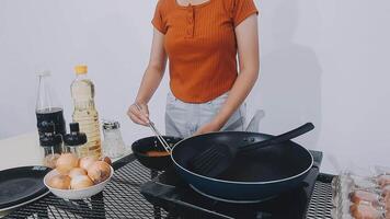 detail shot of a woman removing an egg from the frying pan with a spatula, preparing the typical colombian breakfast video