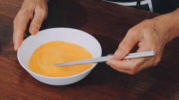 detail shot of a woman removing an egg from the frying pan with a spatula, preparing the typical colombian breakfast video