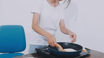 detail shot of a woman removing an egg from the frying pan with a spatula, preparing the typical colombian breakfast video