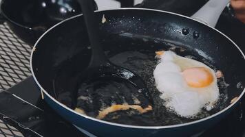 detail shot of a woman removing an egg from the frying pan with a spatula, preparing the typical colombian breakfast video