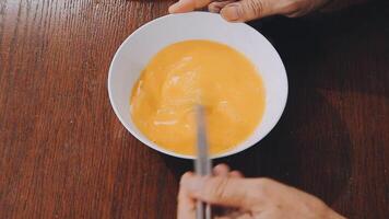 detail shot of a woman removing an egg from the frying pan with a spatula, preparing the typical colombian breakfast video