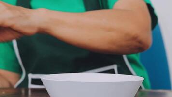 detail shot of a woman removing an egg from the frying pan with a spatula, preparing the typical colombian breakfast video