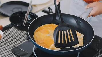 detail shot of a woman removing an egg from the frying pan with a spatula, preparing the typical colombian breakfast video