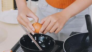 detail shot of a woman removing an egg from the frying pan with a spatula, preparing the typical colombian breakfast video