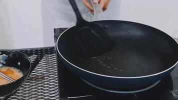 detail shot of a woman removing an egg from the frying pan with a spatula, preparing the typical colombian breakfast video