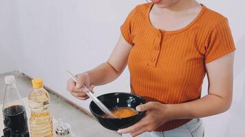 detail shot of a woman removing an egg from the frying pan with a spatula, preparing the typical colombian breakfast video