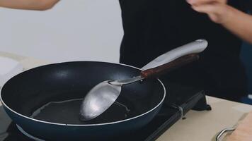 detail shot of a woman removing an egg from the frying pan with a spatula, preparing the typical colombian breakfast video
