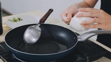 detail shot of a woman removing an egg from the frying pan with a spatula, preparing the typical colombian breakfast video