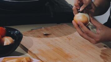 Woman using knife and hands cutting cucumber on wooden board in kitchen room. video