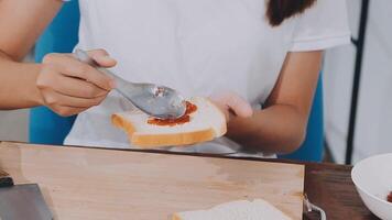 Detail of female hands adding salami on a sandwich woman making hot sandwiches for breakfast in a sandwich maker video