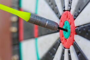 View on a fragment of dartboard with dart in a bullseye photo